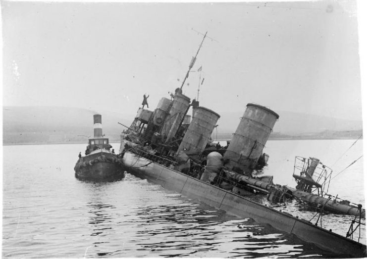 A tug alongside the scuttled G102