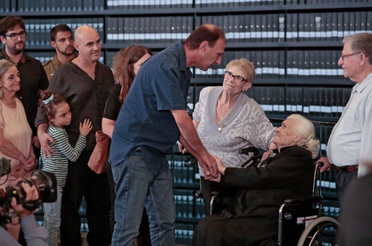 Melpomeni Dina greets descendants of holocaust survivors. GETTY