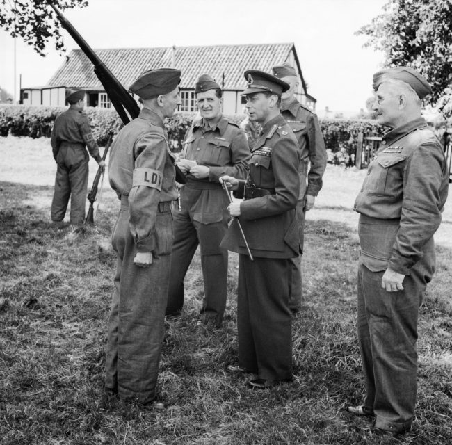 King George VI talking to a member of the Home Guard during an inspection in Kent, 10 August 1940.