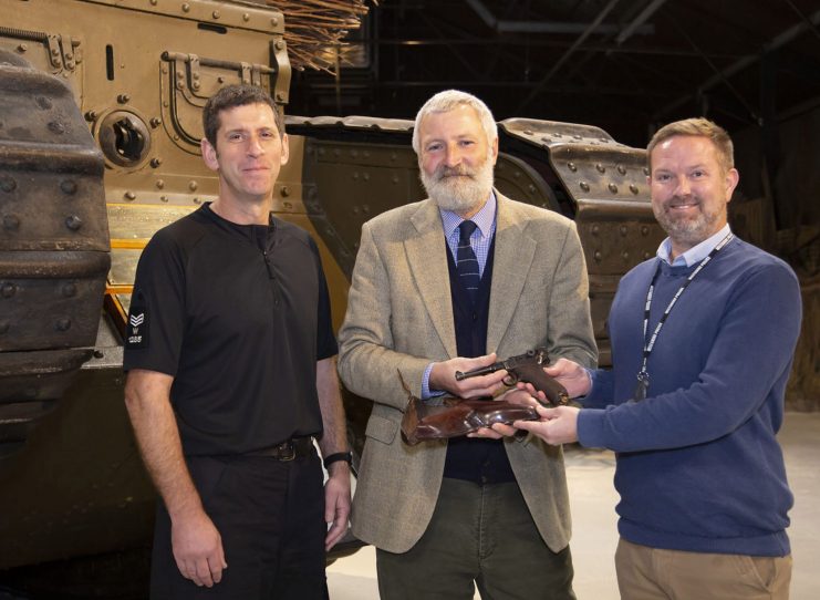 Tank Museum receives discovered Luger from Wiltshire police (l-r) Sgt Bill Monk (Specialist Operations), Tank Museum curator David Willey and Force Armourer Jamie Ross. Photo: The Tank Museum.
