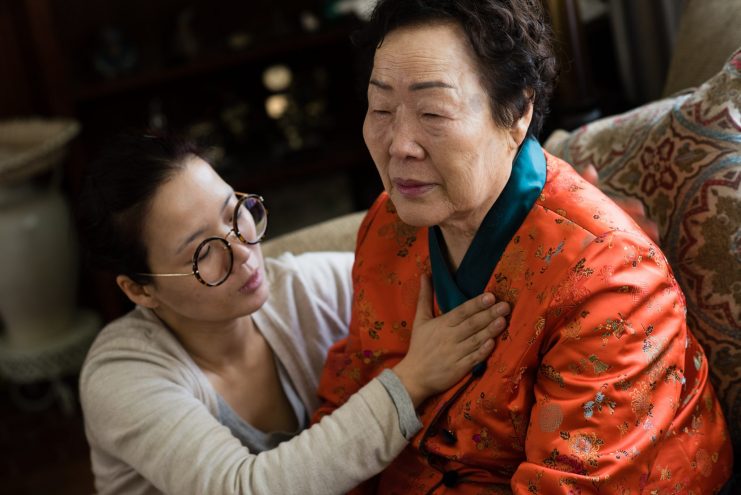 WW2 Korean Comfort Woman, Yong Soo Lee, 86, is visiting from Korea to speak out about her experience. As she tells her emotional story, her travel companion form Korea, Kwark Hae Kyoung, touches her heart and pats her back. Korean “comfort women” were forced to be prostitutes by the Japanese military during world war II. (Photo by Sarah L. Voisin/The Washington Post via Getty Images)