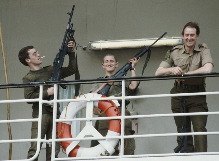 A group of British soldiers show of their rifles as they stand on the deck of the RMS Queen Elizabeth 2 (QE2) before the ship departs for the Falklands, from Southampton docks on Wednesday, May 12, 1982. The QE2 took part in the Falklands War during 1982, carrying troops and volunteer crew to the South Atlantic conflict, with her decks converted into three helicopter landing pads. (Photo by Bryn Colton/Getty Images)