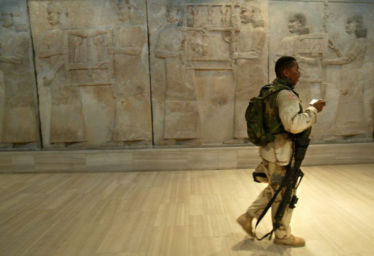 Monuments Men. A US soldier from the 1st Division, 2nd Bridage, Texas, strolls the corridor during a visit to the Iraq Museum 10 September 2003 in Baghdad.