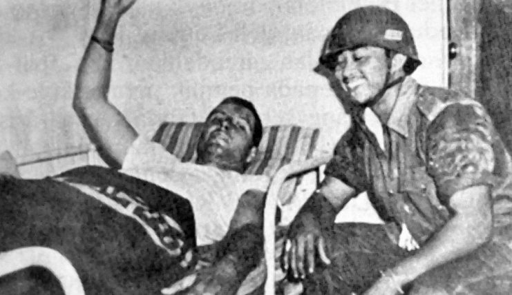 Photo above; Allen L Pope captured and recovering in a hotel. After his escape from the crippled A-26, Pope baled out but fractured his right leg, hit by the tail fin. Pope was held not in prison but under house arrest and treated very well as being an American Citizen/ Prisoner that could be traded against US Goodies. But for raising his price, in April 1960 they first court-martialed him, found him guilty of killing 17 members of Indonesia’s armed forces and six civilians and sentenced him to death. It was finally Robert Kennedy who, in 1962, bailed him out in exchange for an arms deal with the Indonesians.