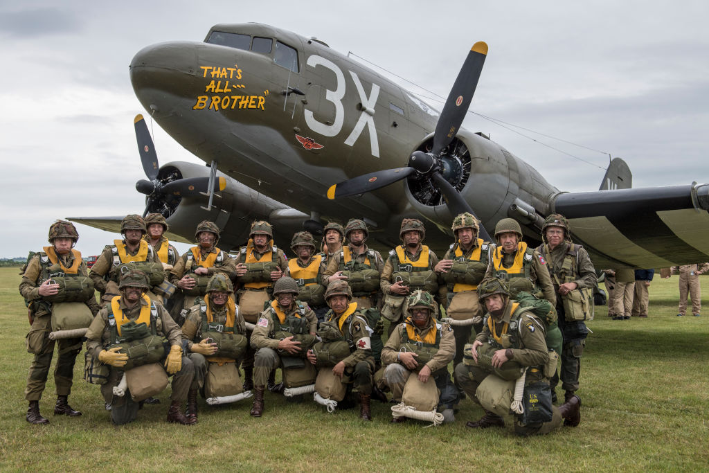 DUXFORD, UNITED KINGDOM - JUNE 04: American period parachutists pose for a photograph on June 4, 2019 at IWM Duxford, Cambridgeshire, England. The museum hosts the greatest number of Douglas C-47 Skytrain aircraft in one location since the Second World War. 