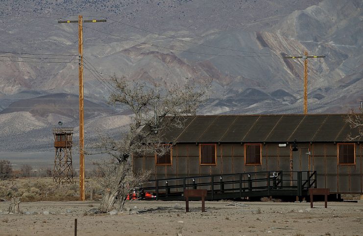 A replica of internment camp barracks sits near a watch tower at Manzanar National Historic Site.