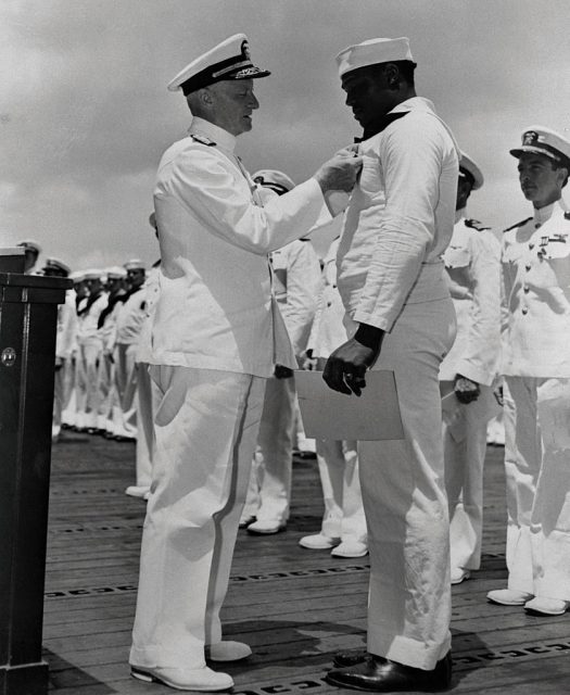 (Original Caption) Admiral Chester W. Nimitz pins the Navy Cross on Doris Miller, the first Negro to win the award, in ceremony aboard a warship at Pearl Harbor.