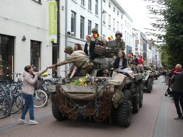 A victory parade of authentic World War II vehicles driving through Hasselt.