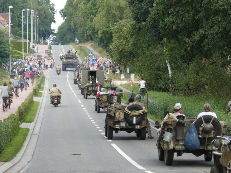 Column of historical vehicles progresses through the streets of As.
