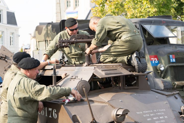 Participants of the liberation column performing maintenance on one of the column’s Daimler Dingo vehicles.