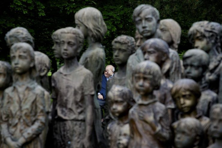 A man reacts behind the memorial dedicated to the 82 local children gassed by Nazis forces, is seen during a remembrance ceremony commemorating the 71st anniversary of the destruction of the Lidice.  (Photo by Matej Divizna/Getty Images)