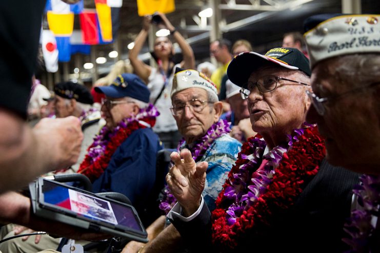 Ken Free shares photos with USS Arizona survivor Donald Stratton before the start of a ceremony commemorating the 75th anniversary of the attack on Pearl Harbor at Kilo Pier on December 07, 2016 in Honolulu, Hawaii. (Photo by Kent Nishimura/Getty Images)