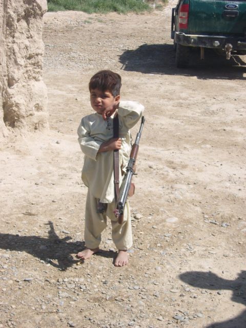 The son of an ANP commander, wielding an assualt rifle!