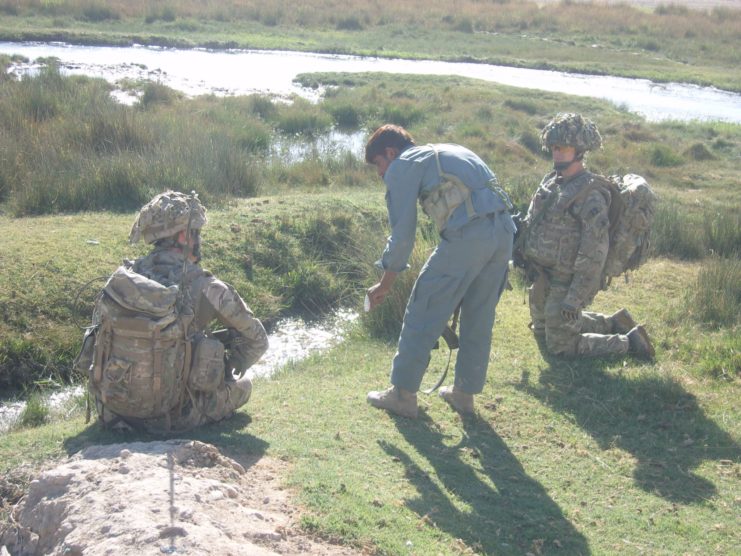 Men talk on land that could be the UK, rather than Afghanistan.