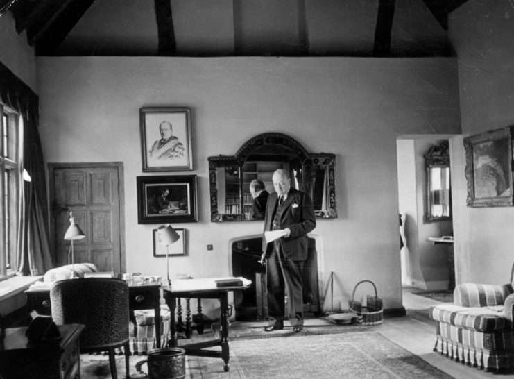 Sir Winston Churchill (1874-1965), British politician and First Lord of the Admiralty, standing by a mirror reading a document in the study of his country home, Chartwell Manor, in Westerham, Kent, England, United Kingdom, in October 1939. (Photo by Topical Press Agency/Hulton Archive/Getty Images)