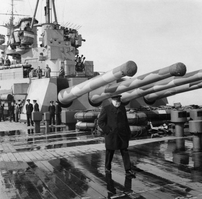 The Royal Navy During The Second World War, The Prime Minister Winston Churchill on board HMS PRINCE OF WALES during his journey to America to meet with President Roosevelt. The quadruple 14 inch guns of Y turret can be seen in the background, August 1941. (Photo by Capt. Horton/ Imperial War Museums via Getty Images)
