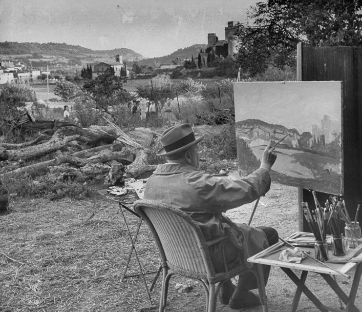 Winston Churchill sitting at his easel painting and smoking a cigar. (Photo by Frank Scherschel/The LIFE Picture Collection via Getty Images)