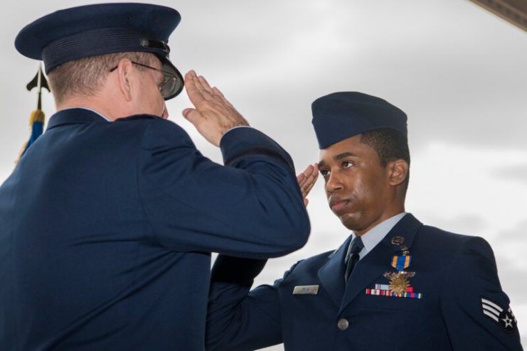 Lt. Gen. Jim Slife, commander of Air Force Special Operations Command, presents an Air Medal to Senior Airman Zadok Dean, aerial gunner for Spooky 41, during a ceremony at Hurlburt Field, Florida, Mar. 2. (Senior Airman Joseph Leveille/Air Force)