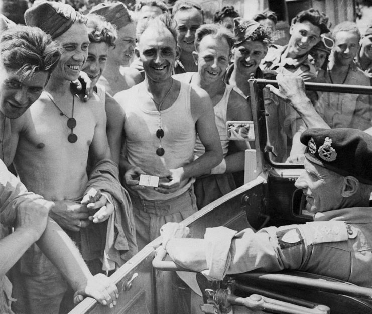 (Original Caption) “Monty” talks with front line sappers in Sicily… Sicily- Near the front line, General Bernard (Monty) Montgomery stops his car to chat with some of his men who were working on the road.