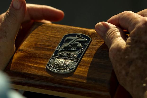 U.S. Army Private Edward Bloch, a survivor of the attack on Hickam Field, holds a wooden box given to him during the 75th Commemoration of the Dec. 7, 1941 attack on Hickam Field ceremony at Joint Base Pearl Harbor-Hickam, Hawaii. (Nathan Allen/U.S. Air Force)