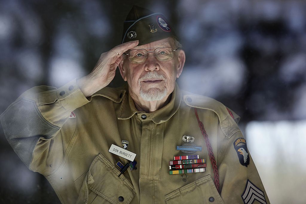  Donald R. Burgett, 89, salutes as he poses for a portrait at his home 