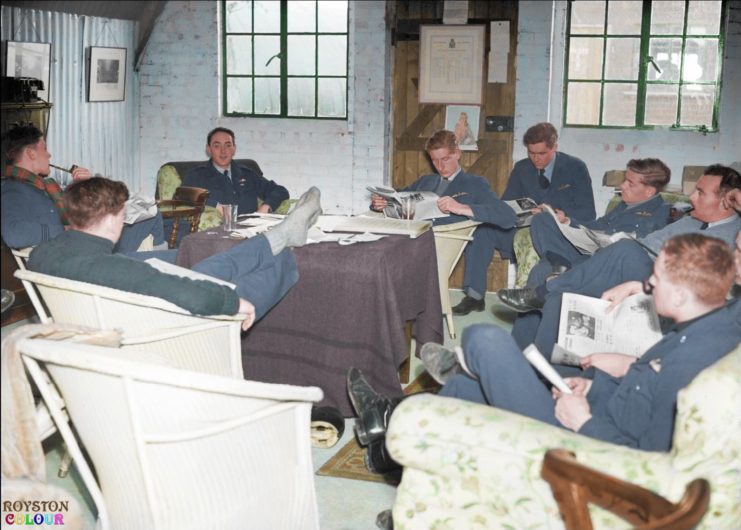 Squadron Leader Brian J E “Sandy” Lane, the Commanding Officer of No. 19 Squadron RAF (facing the camera), relaxes with some of his pilots in the Squadron crew room at Manor Farm, Fowlmere, Cambridgeshire, UK. September 1940. (Colourised by Royston Leonard from the UK)