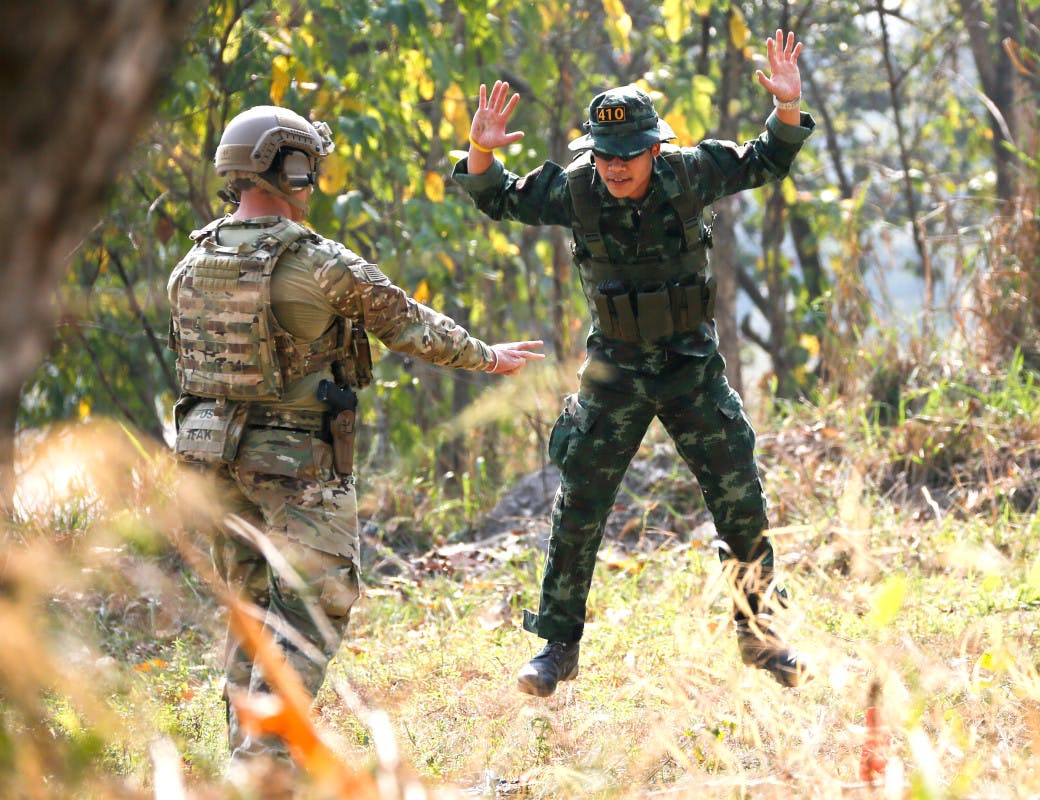 A member of the US Army's 1st Battalion, 1st Special Forces Group works with a member of the Royal Thai Armed Forces during Balance Torch 16-2 in 2016.