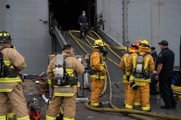 Sailors and Federal San Diego Firefighters prepare to relieve hose teams on board USS Bonhomme Richard (LHD 6) on the morning of July 13, 2020. (U.S. Navy/Mass Communications Specialist Seaman Lily Gebauer)