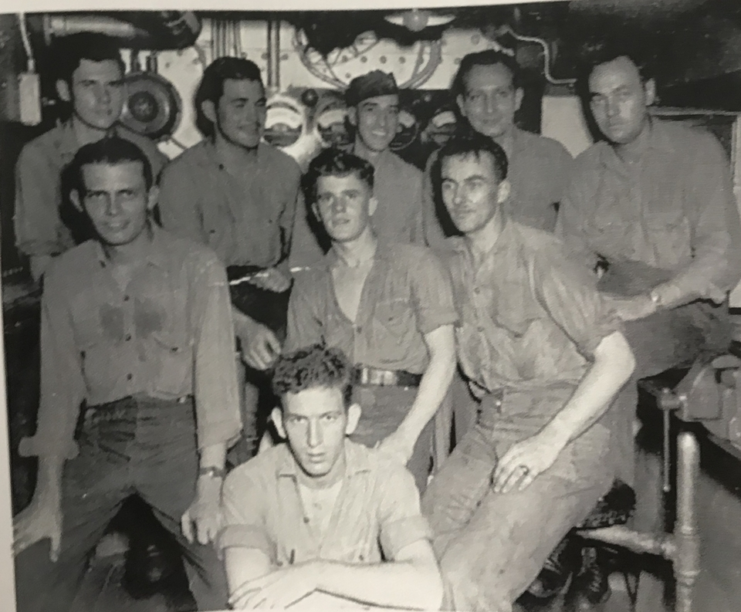 Floyd Welch, 96, of East Lyme, center front, is seen with other crewmembers of the USS Maryland in the Interior Communications shop aboard the ship in this undated photo. (Courtesy of the Welch family).