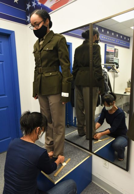 A female soldier attending the Army Recruiter Course at Fort Knox, Ky., has her pants hem measured. U.S. ARMY