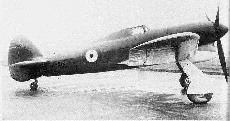 The unarmed first prototype Typhoon P5212 taken just before its first flight. The prototype had a small tail unit and a solid fairing behind the cockpit, which was fitted with “car door” access hatches; no inner wheel doors were fitted and the Sabre engine used three exhaust stubs either side of the cowling.