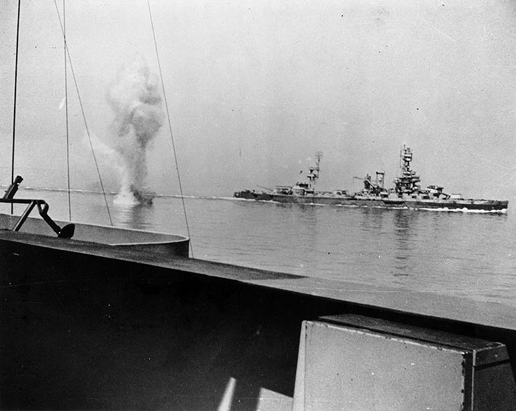 A heavy German coast artillery shell falls between Texas (in the background) and Arkansas while the two battleships were engaging Battery Hamburg during the battle of Cherbourg, France, 25 June 1944