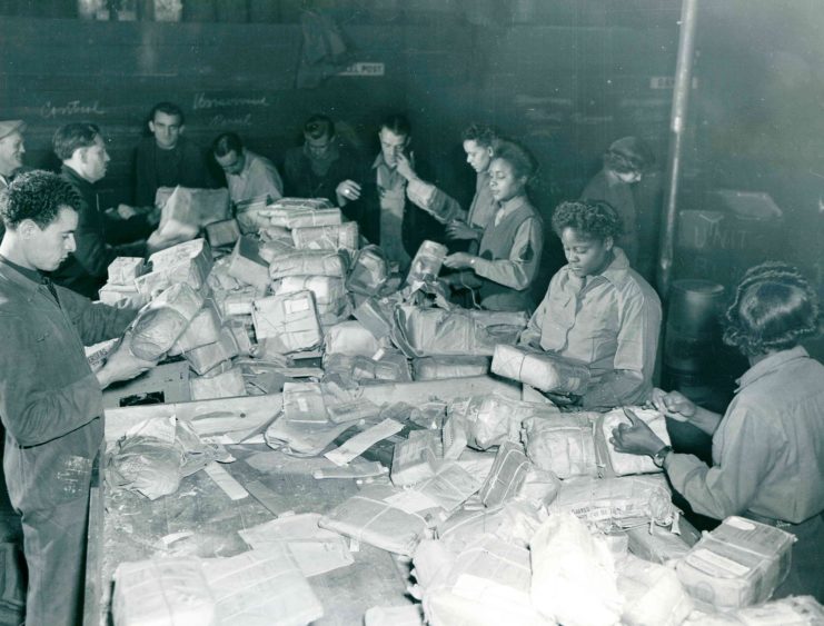 The Six Triple Eight and civilian postal employees sorting mail in France in November 1945, two months after the war ended.Credit…National Archives