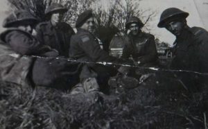 Bob Roberts (centre) and his comrades briefly rest during the battle of Normandy.