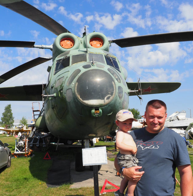 Pavels who helps run the museum wiith an Mil Mi-6 troop carrying helicopter at Riga Air Museum. Picture: Geoff Moore/www.thetraveltrunk.net