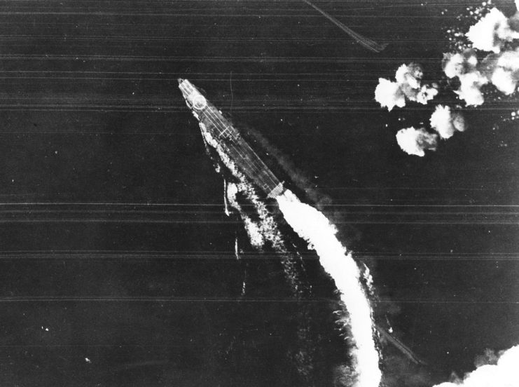 A B-17 attack misses Hiryū; this was taken between 08:00–08:30. A Shotai of three Zeros is lined up near the bridge. This was one of several combat air patrols launched during the day.