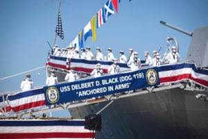 Crew man the USS Delbert D. Black at the private commissioning ceremony at Port Canaveral.
