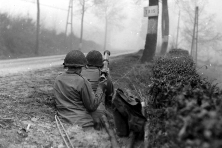 An 82nd anti-armor bazooka team covers a road near Cheneux on December 20, 1944.