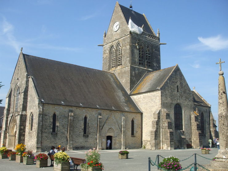 The famous parachute on the church at Sainte Mère Eglise, where John Steele remained for over two hours pretending to be dead. Elliesram13 CC BY-SA 3.0