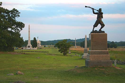 Cemetery Ridge, looking south along the ridge with Little Round Top and Big Round Top in the distance. The monument in the foreground is the 72nd Pennsylvania Infantry Monument.