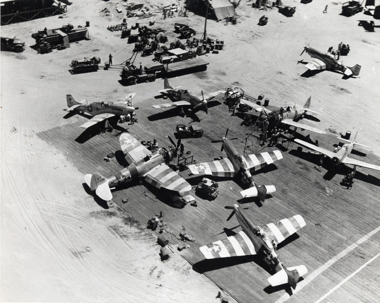 P-51D Mustangs and Republic P-47D Thunderbolts fighters undergo maintenance at Lingayen airfield in the Philippines in April 1945. The air force hero flew the P-47D Thunderbolt.