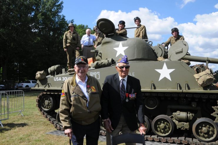 Veterans Clarence Smoyer and Joe Caserta stand near a Sherman tank, similar to the ones they were both crewmembers of during World War II. Both men were present in their respective tanks in Cologne, Germany, March 6, 1945, when Smoyer’s tank crew “Eagle 7,” took out a German tank.