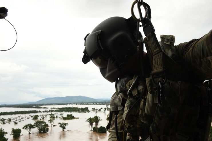 A U.S. Army HH-60 Black Hawk helicopter crew member surveys Hurricane Eta’s high floodwaters for stranded survivors at San Pedro Sula, Honduras, Nov. 6, 2020.