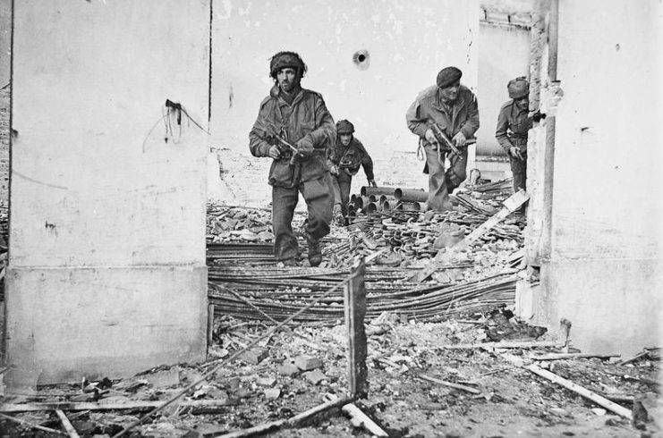 British paratroopers move through ruined houses in Arnhem.