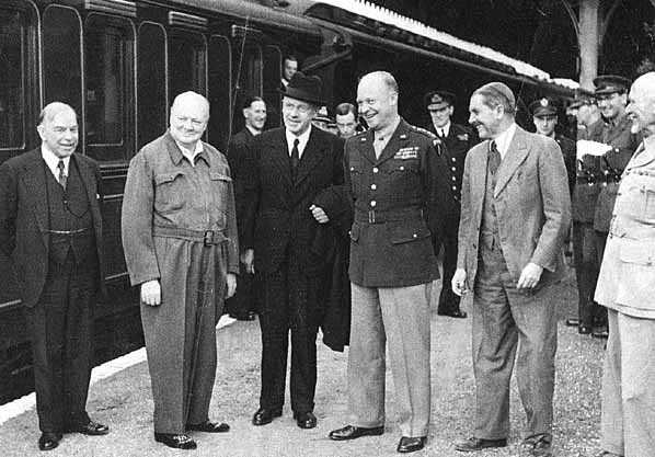 An image of William Lyon Mackenzie King, Winston Churchill, Peter Fraser, Dwight Eisenhower, Godfrey Huggins and Jan Smuts, mid-1944. This photo was allegedly taken at Droxford Station, although it is unclear if this is true.