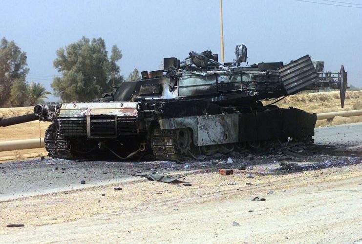 A destroyed US Military M1A1 Main Battle Tank (MBT) sits along Route 1, in Iraq, during Operation IRAQI FREEDOM.
