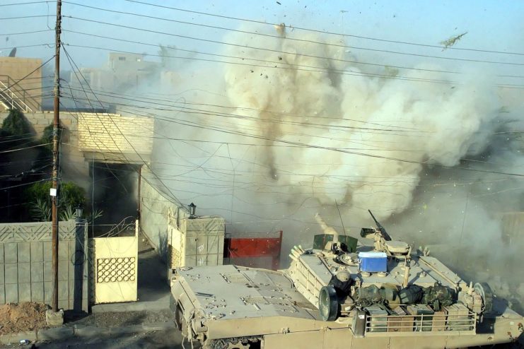 A US Marine Corps (USMC) Marine M1A1 Abrams Main Battle Tank (MBT), 2nd Tank Battalion (BN), fires its main gun into a building to provide suppressive counter fire against terrorists who fired on other USMC Marines during a fire fight in Fallujah, Al Anbar Province, Iraq. These Marines are participating in Operation AL FAJR, which is an offensive operation conducted against Iraqi terrorist forces as part of a Security and Stabilization Operation (SASO) carried out during Operation IRAQI FREEDOM. (Released to Public)