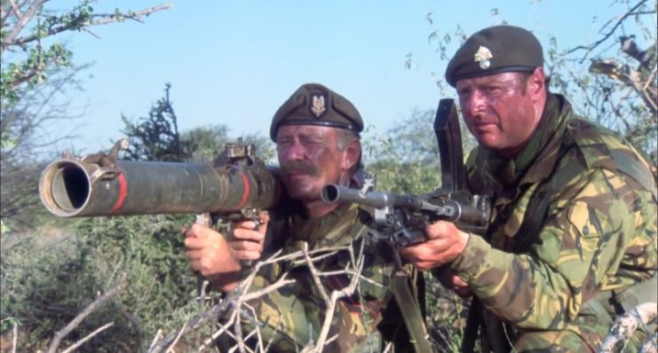 Sgt. Tosh Donaldson (Ian Yule) holds his Blindicide Rocket Launcher while another mercenary fires his Bren gun. (Photo by Richmond Film Productions Ltd./Victory Films/Varius Entertainment Trading AG/Sunset Boulevard/Corbis via Getty Images)