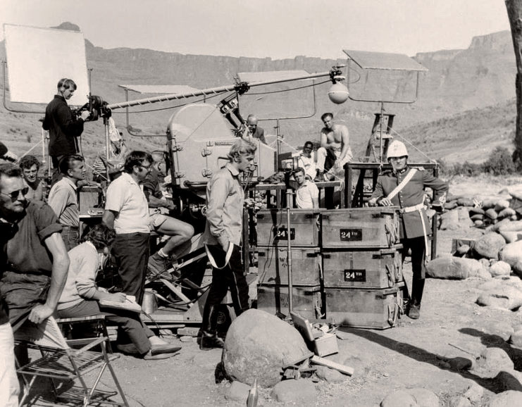 A break in shooting on location with stars Michael Caine and Stanley Baker present.