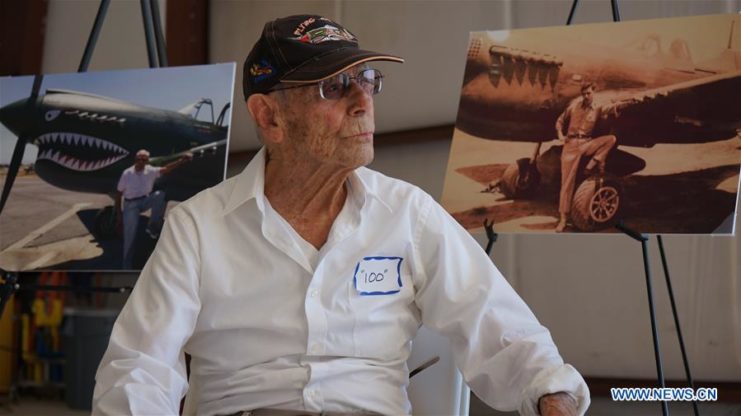 Harry Moyer sits with photos of himself and WWII aircraft. Photo by Zeng Hui Xinhua